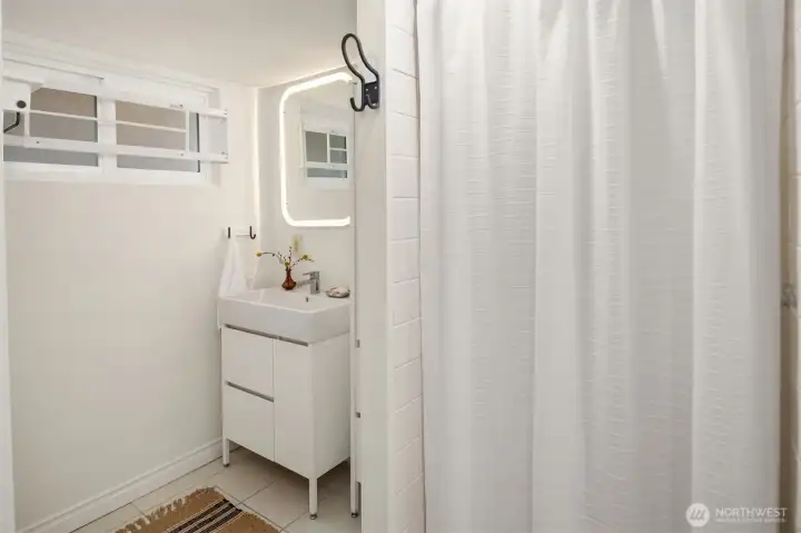 Lower-level bathroom features a walk-in shower.