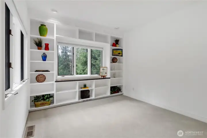 Office with bookcase and seating area.