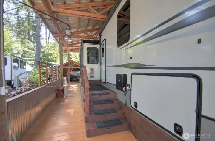 SIDE OF THE RV FULL DECKING WITH HALF WALL AND GREAT LIGHTING