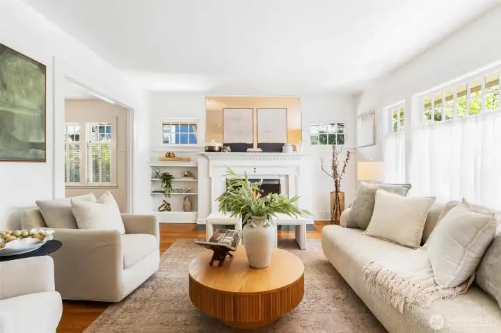 Bright, light-filled living room featuring custom built-in shelving.