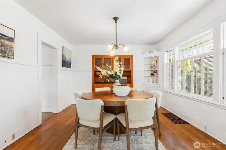 Bright, spacious dining room featuring custom built-ins that provide ample storage and a sophisticated touch.
