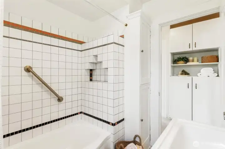 Bathroom leads to hallway to custom built-in cabinetry for ample storage.