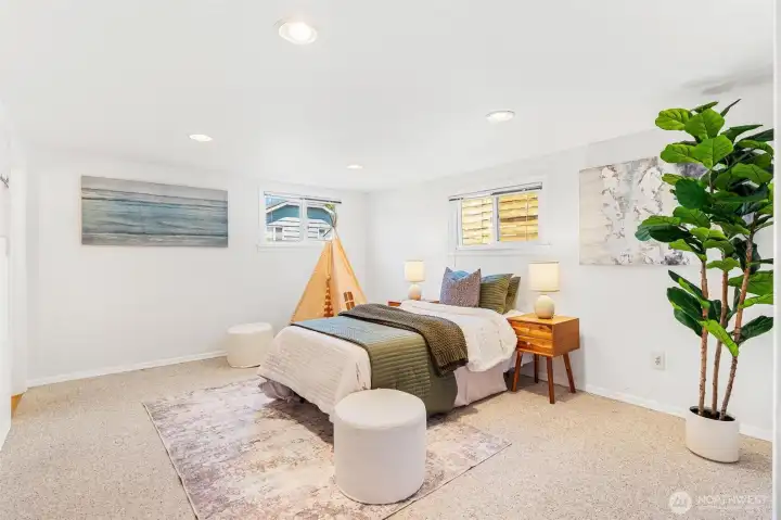 Spacious downstairs bedroom featuring a private ensuite 3/4 bath; perfect for a guest suite, home office, or a versatile combination of both.