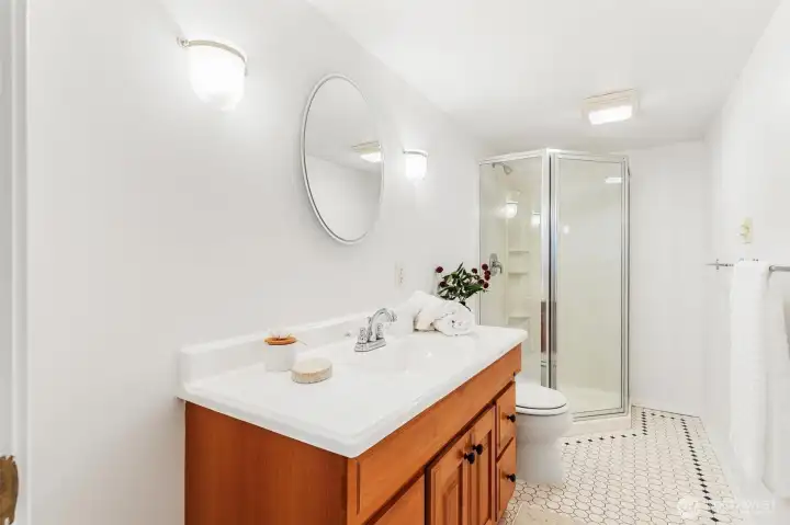 Downstairs 3/4 bathroom with modern fixtures and tile flooring.