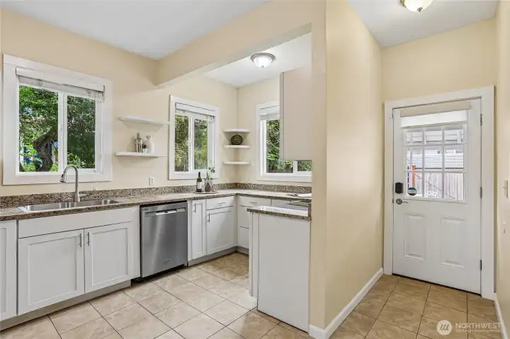 Kitchen off of dining room and door leading to backyard. Brand new stainless range and stainless dishwasher and refridgerator.