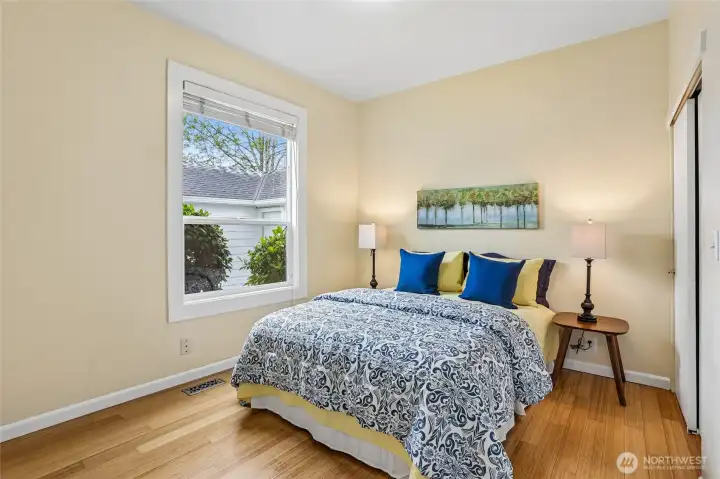 Main floor bedroom with closet and views of the backyard.