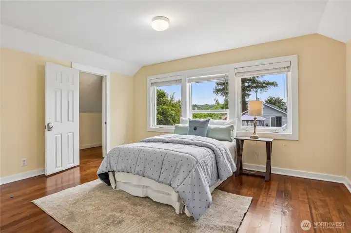 Large upper floor bedroom with views of the backyard and huge walk in closet.
