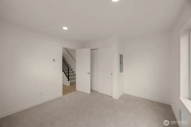 This room’s layout offers seamless flow to the stairwell, closet, and natural light from multiple windows.