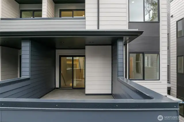 The covered back patio space provides privacy and shade, perfect for outdoor lounging.