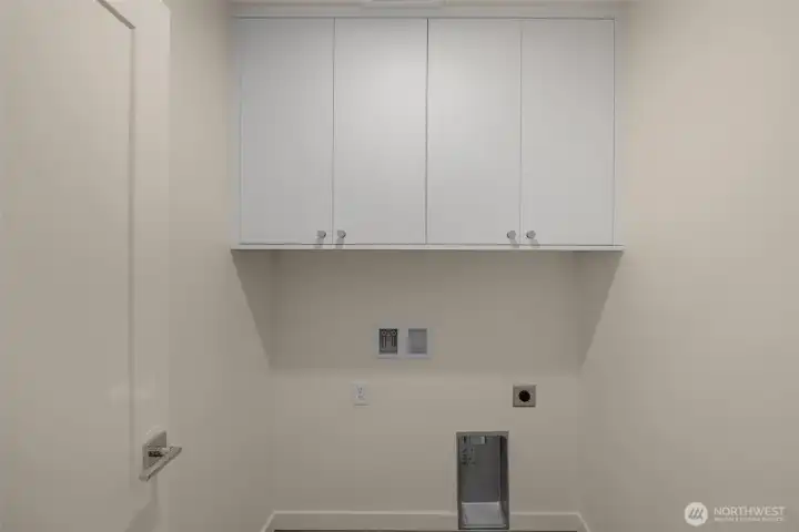 Tucked away, your laundry room includes upper cabinets and hookups for a side-by-side washer/dryer.