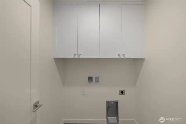 Tucked away, your laundry room includes upper cabinets and hookups for a side-by-side washer/dryer.
