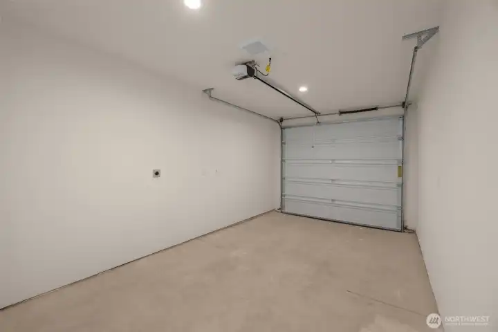 Attached is a garage with clean lines and room for storage, tools, or gym gear.