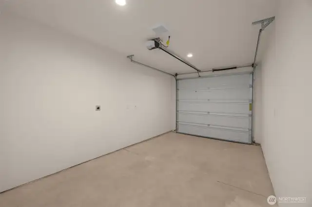 Attached is a garage with clean lines and room for storage, tools, or gym gear.