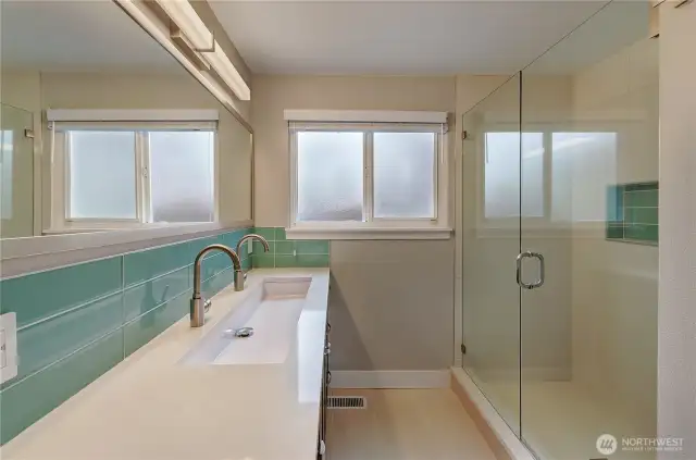 Main bath with slab quartz, elongated sink, dual faucets