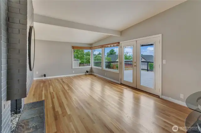 Gleaming hardwoods and XL windows for stunning VIEWS. Doors lead to expansive rear deck
