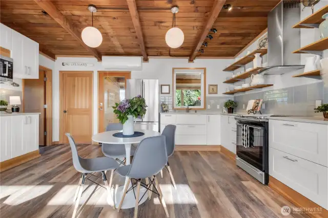 Beautiful great room with original fir vaulted ceilings and waterproof laminate wood plank flooring! Ductless HP for Cooling and Heating! Tankless hot water!