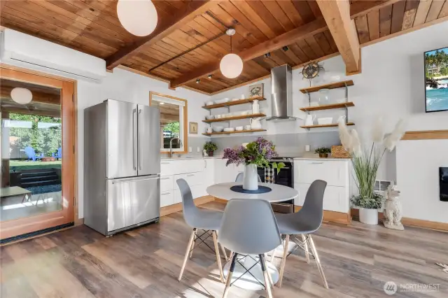Beautiful great room with original fir vaulted ceilings and waterproof laminate wood plank flooring! Ductless HP for Cooling and Heating! Tankless hot water!