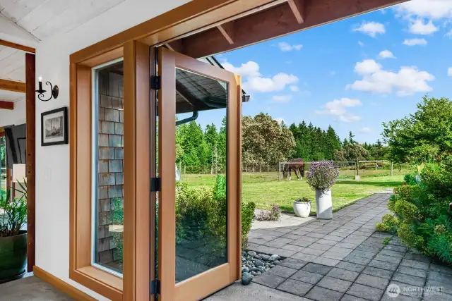 Breezeway doors open to the southern patio, yard and pasture.