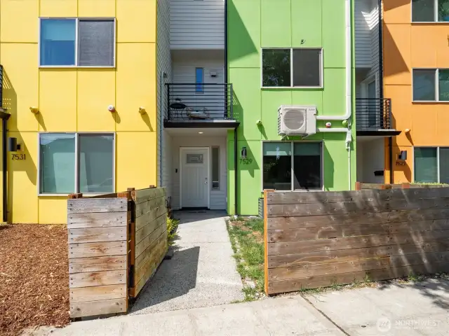 Fully fenced front yard leading to the townhouse. Unit features a mini-split air conditioning system.