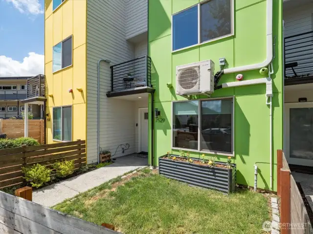 Another look at the fully fenced front yard with garden area.