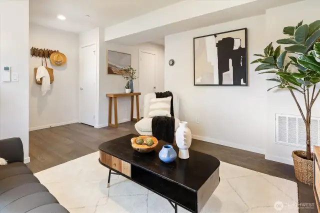 Living room with front entry in the background.