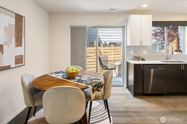 Another look at the dining area, patio and kitchen.