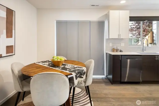 Dining area and kitchen. Note the privacy screen covering the glass sliding doors.