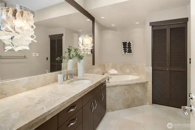 Across the way, the bathroom with waterfall-like glass sconces.