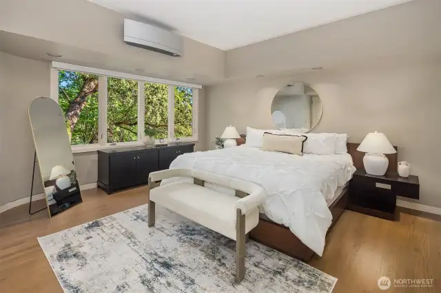 The primary suite is sizable and enjoys privacy away from the living/entertaining spaces: a serene natural view. Watch birds from your own private sanctuary.