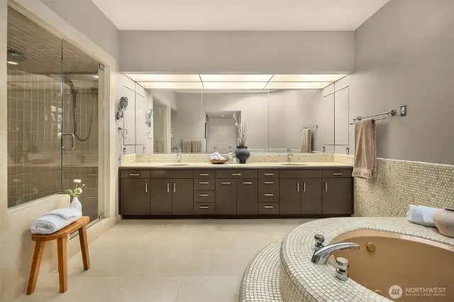 Spa bathroom with shower, deep soaking tub, and dual sink vanity.