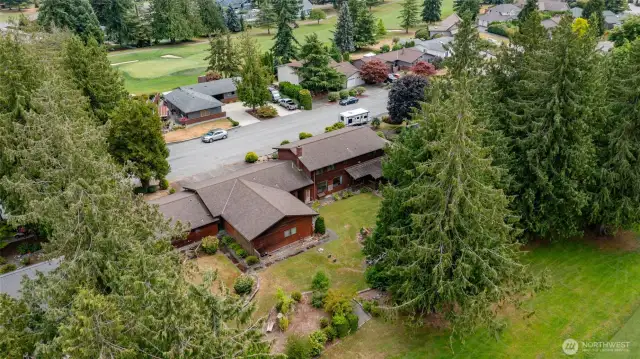 Rear view of the home as it joins with the golf course