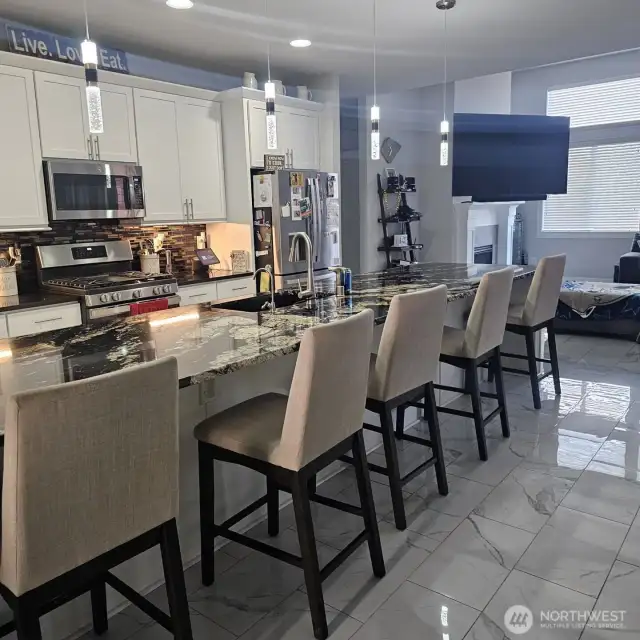 Kitchen displays the 15 foot island, custom lighting and back slash