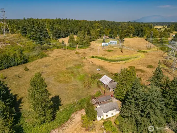 The property runs north under these lines and ends on the other side of them. Take a look at the second photo.