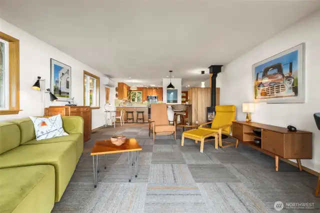 View looking into open living room, dining and work spaces and kitchen