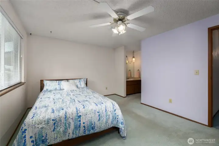 Primary bedroom with walk in closet and full bath