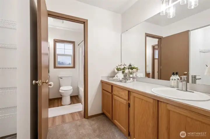Separate vanity off bathroom in primary bedroom.