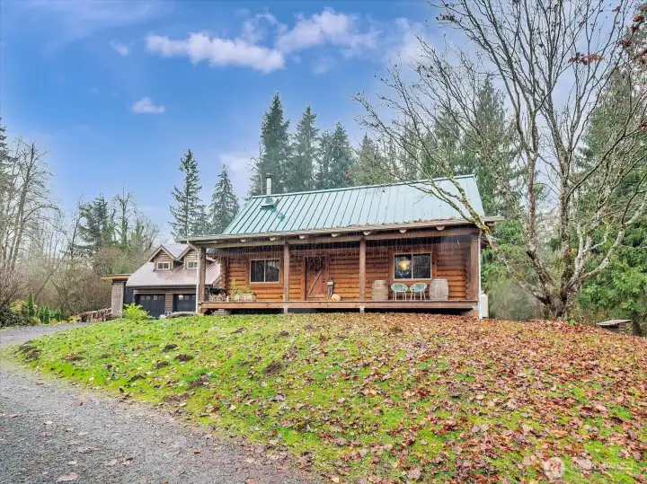Log home in foreground. Garage/shop with MIL unit in background