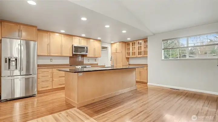 The kitchen is the heart of the home with a spacious island, recessed lighting, and stainless steel appliances.