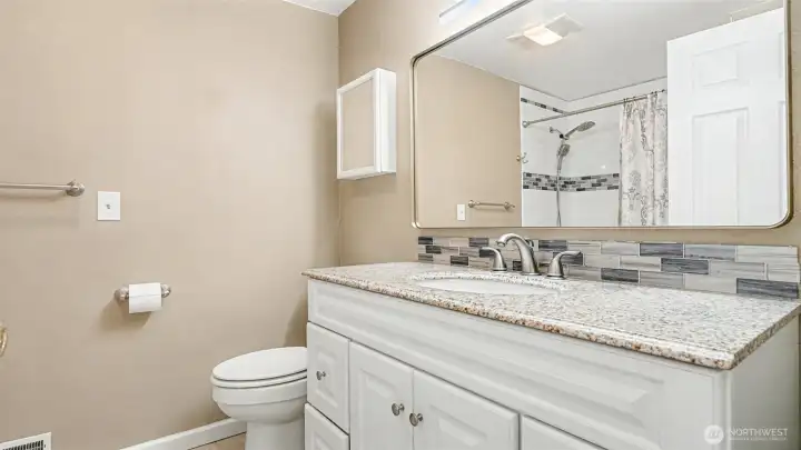 Full sized bathroom across from the guest bedrooms with plenty of counter space and storage.