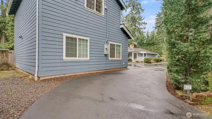 Expansive half circular drive way offers two access points and plenty of room for parking and toys!
