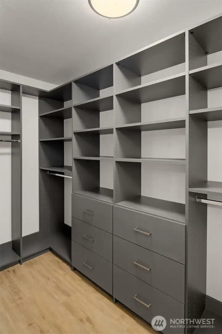 Primary BR walk-in closet with custom built-ins.