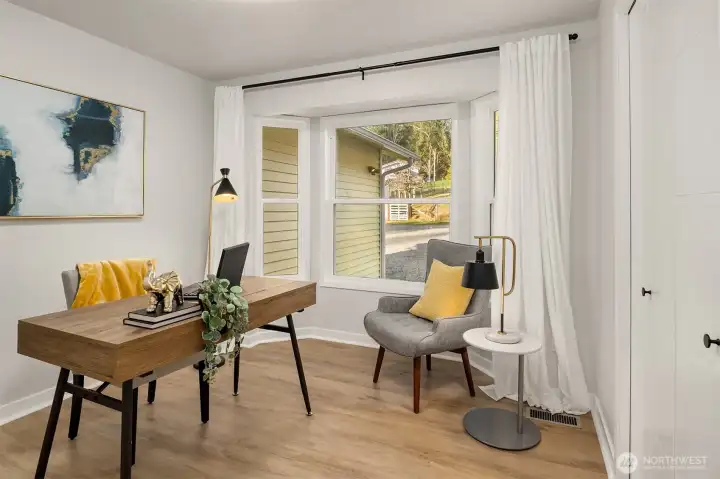 Main floor second bedroom/office with bay window detail & custom closets.