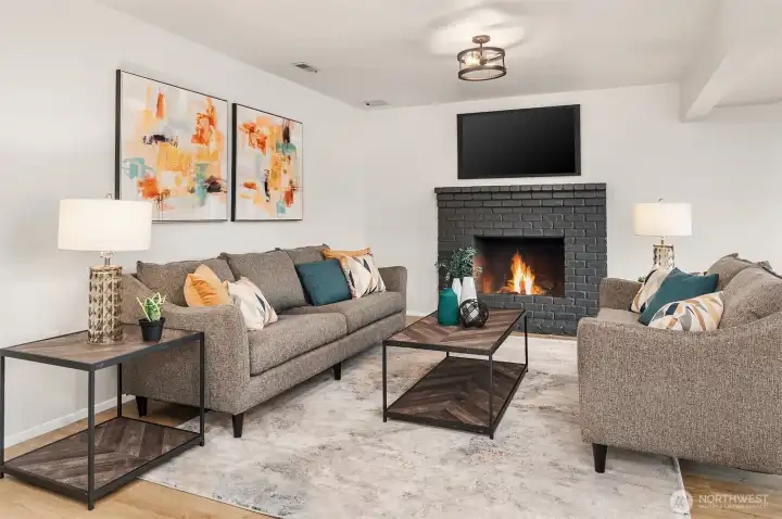 The light and bright lower level rec room features a woodburning fireplace and all new flooring.