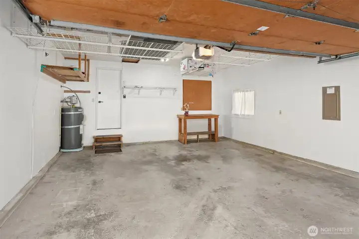 Refreshed 2-car garage with handy suspended storage racks and direct access into the home.