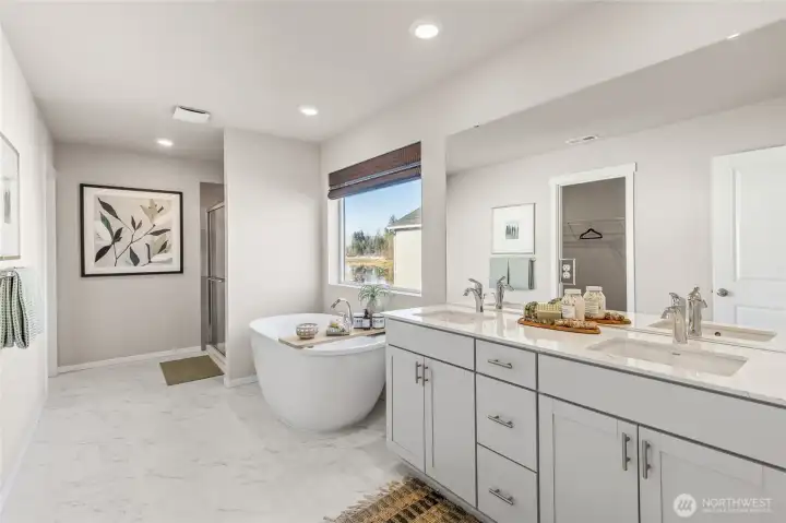 Spa like primary bathroom with freestanding soaker tub, double vanity, and designer shower. Photo is representational. Colors and finishes may vary. See site agent for details.