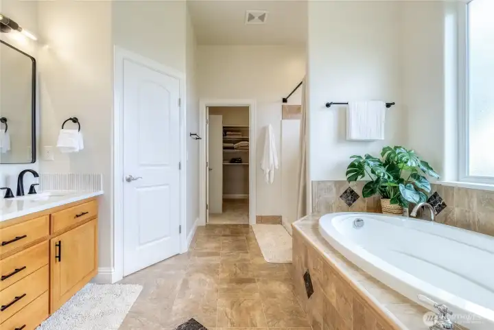 Primary ensuite with double sinks, Roman tub & walk-in closet & separate shower