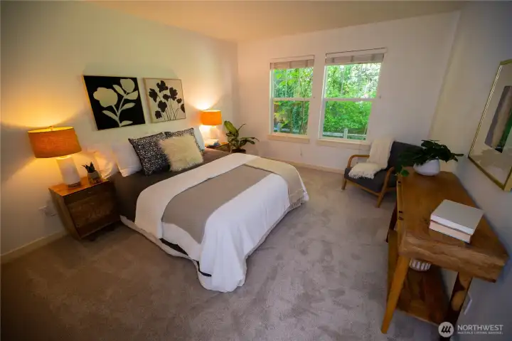 Primary bedroom on the main floor, big private suite that overlooks the forest