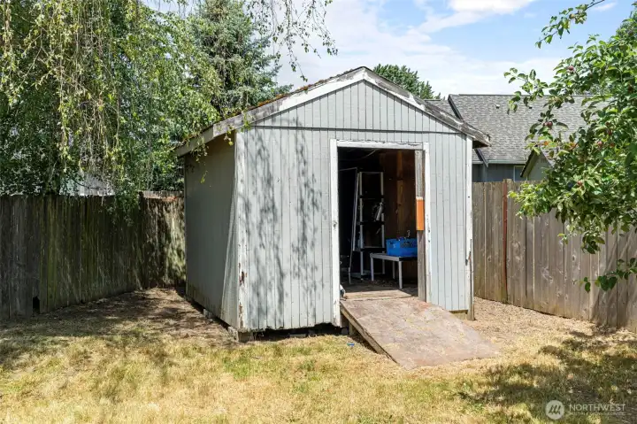 Storage shed in back corner of yard