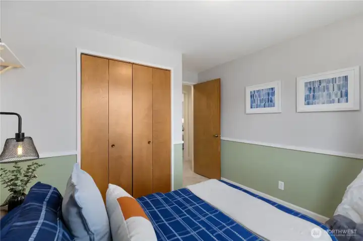 This bedroom features a full-width bifold closet and direct access to the hallway, offering practical storage and a comfortable, functional layout.
