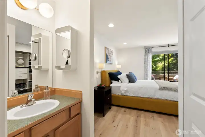 Primary bedroom has its own private vanity and access to the bathroom.